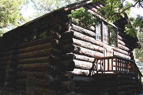 A log cabin with stairs leading to door